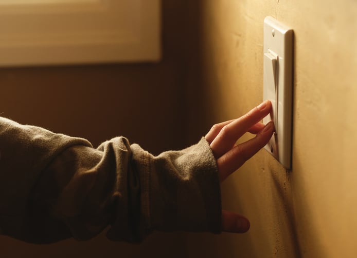 A girl operating a light switch to communicate