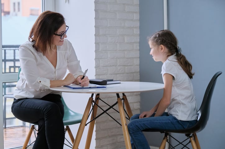 BCBA working with child with autism on planning their day