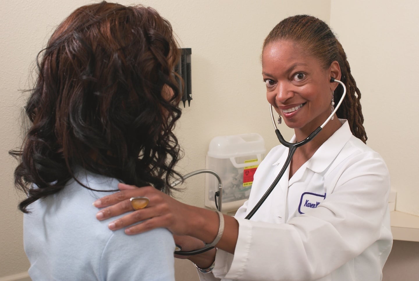 female-doctor-listening-to-woman's-heart