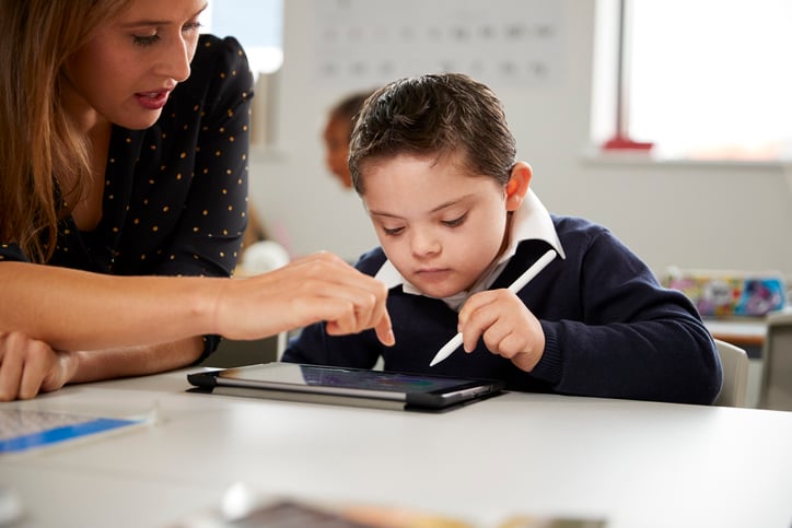 boy learning with aac device