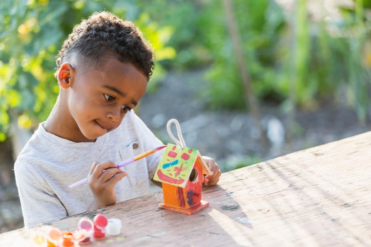 boy-painting-birdhouse