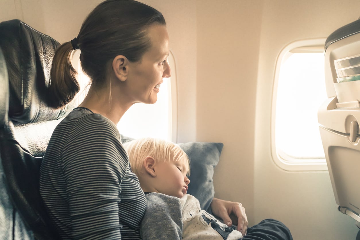 boy sleeping on plane