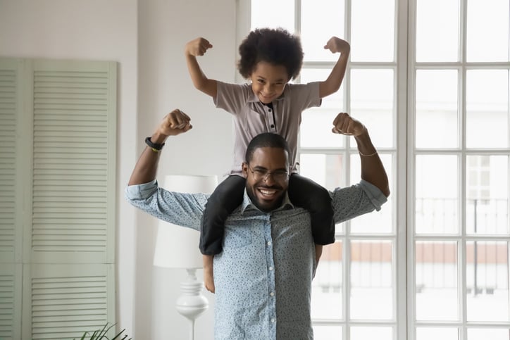 boy with autism being supported and encouraged by his father