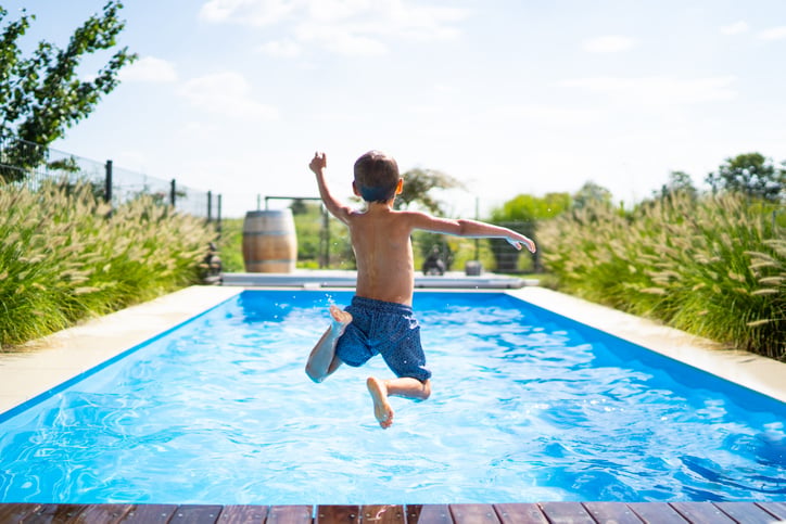 boy with autism jumping into pool developing gross motor skills