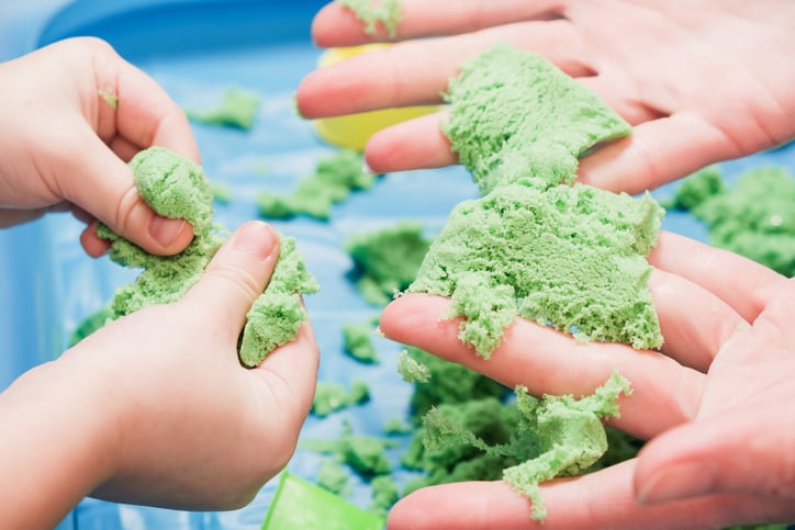 Children with autism playing kinetic colored sensory sand