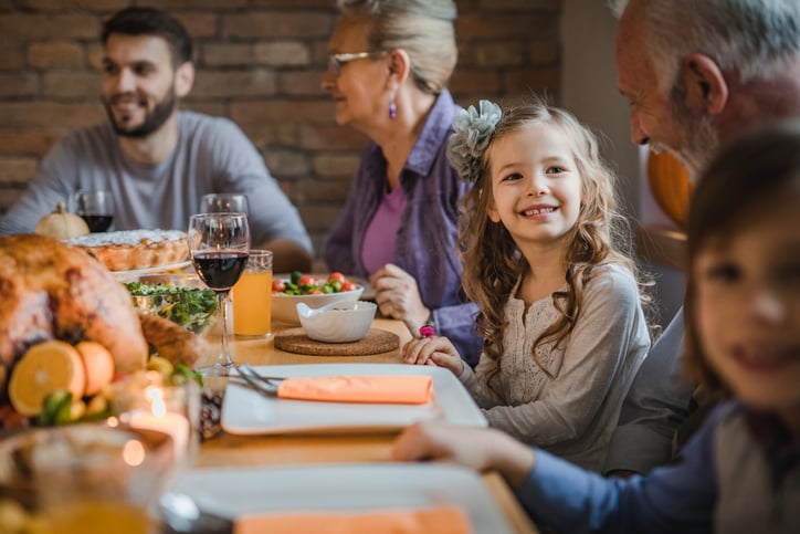 family at thanksgiving table with daughter with autism