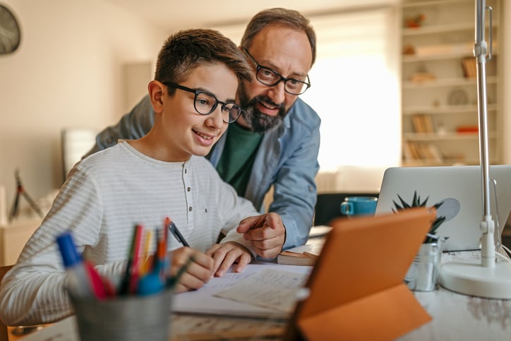 father-helping-son-with-autism-online-learning