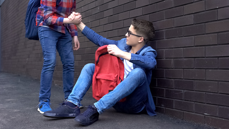 friend-helping-boy-up