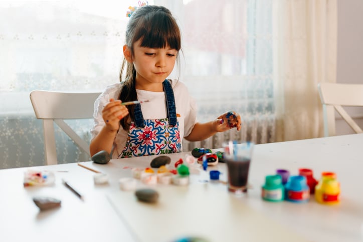 girl-painting-kindness-rocks