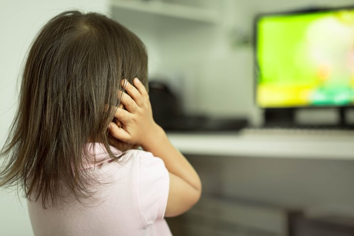 girl with autism covering ears