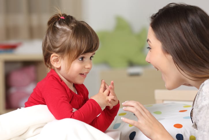 girl with autism talking to her mother