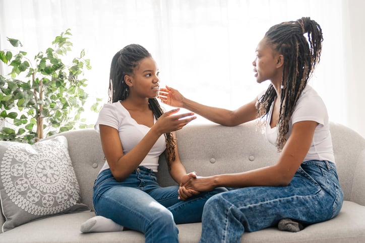 girl with autism talking with her mother