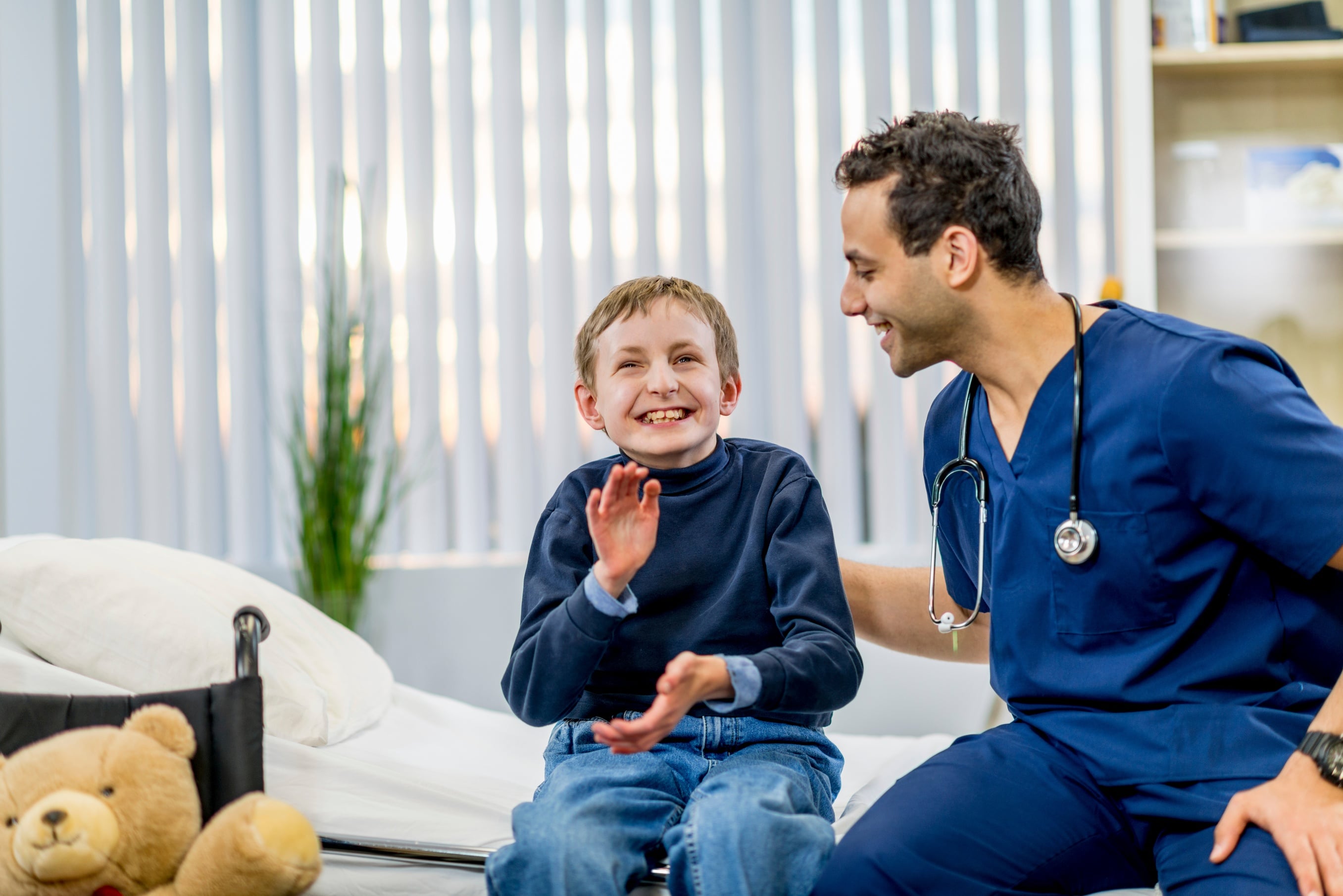 boy with autism interacting with male doctor