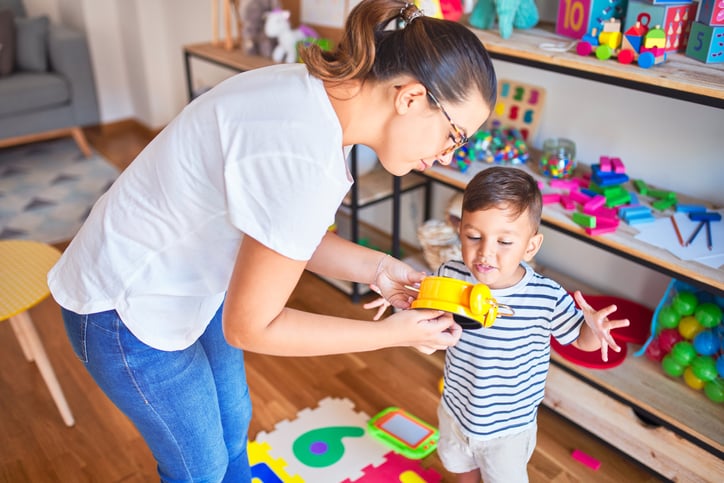 autism early childhood education boy playing with sensory toys