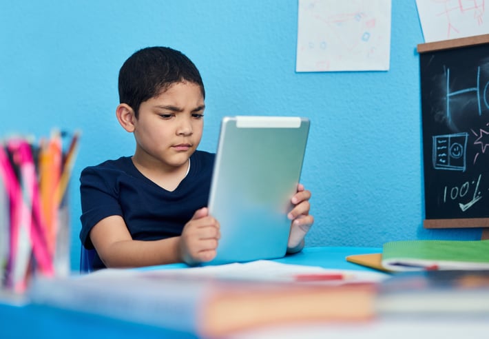 Boy with autism with learning disabilities looking frustrated