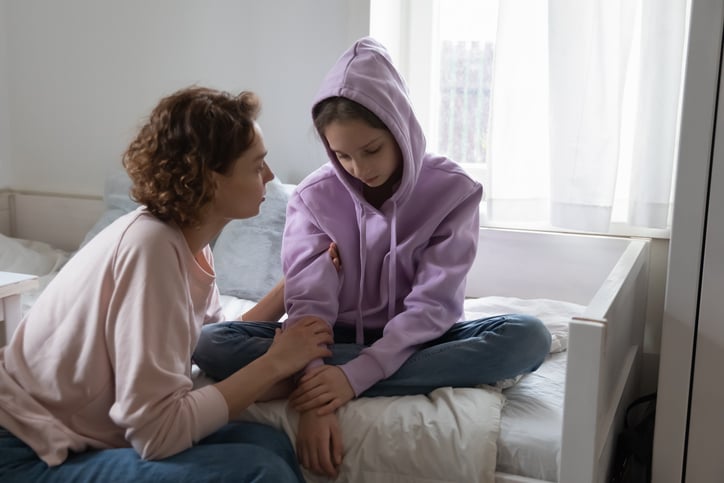 child with autism confiding in mother