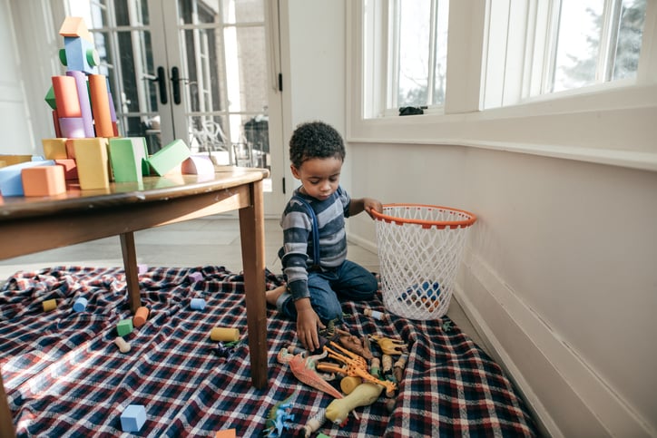 child with autism putting away blocks