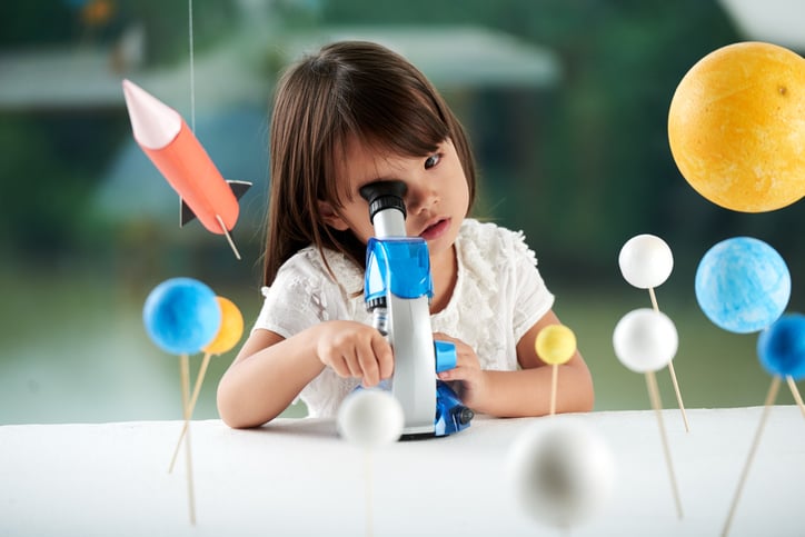 curious asian girl studying science