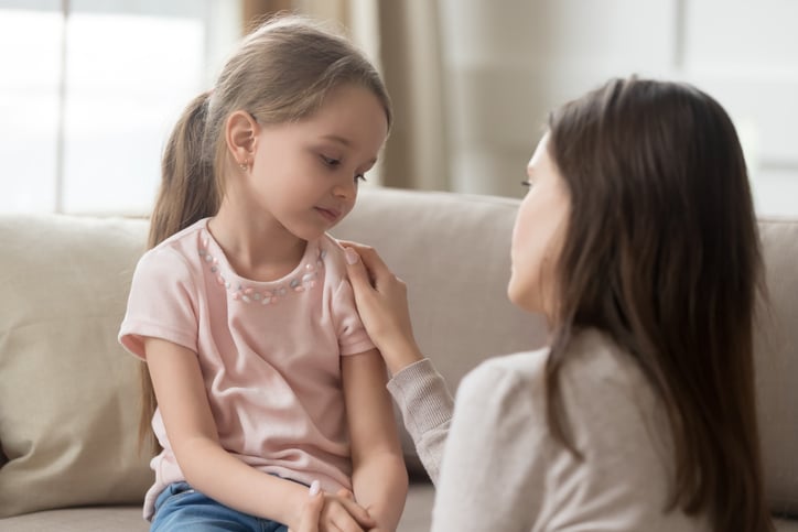 girl with autism being comforted by mother