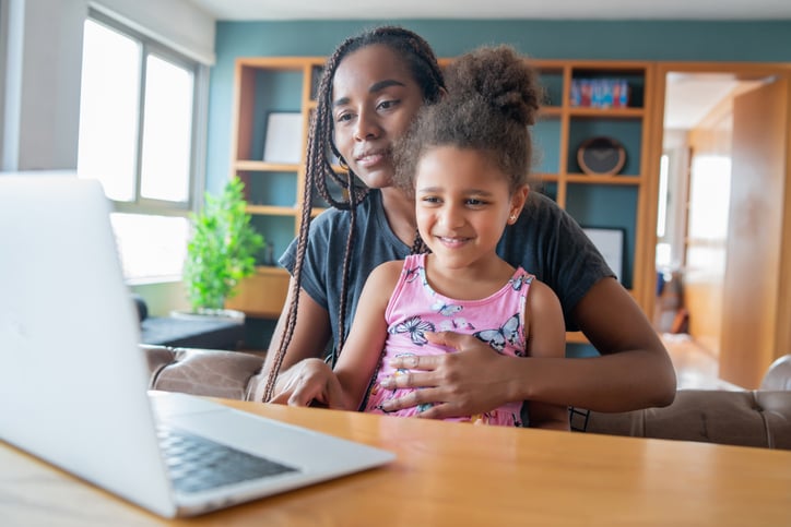 Mother and daughter with autism on a video call with a telehealth provider