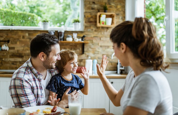 mother high fiving child with autism