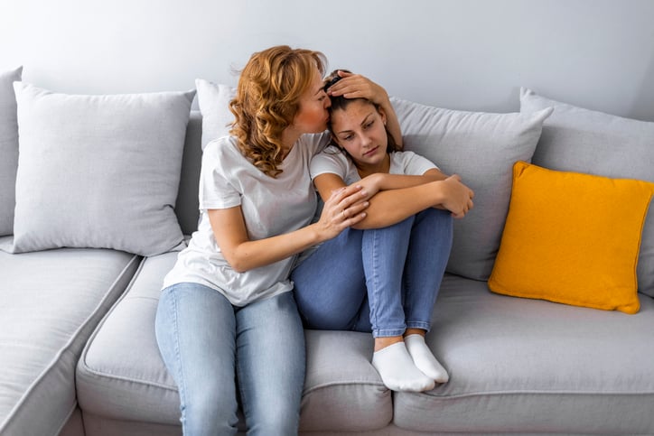 mother kissing daughter with autism