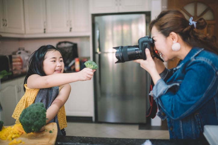 mother recording daughter with autism cooking