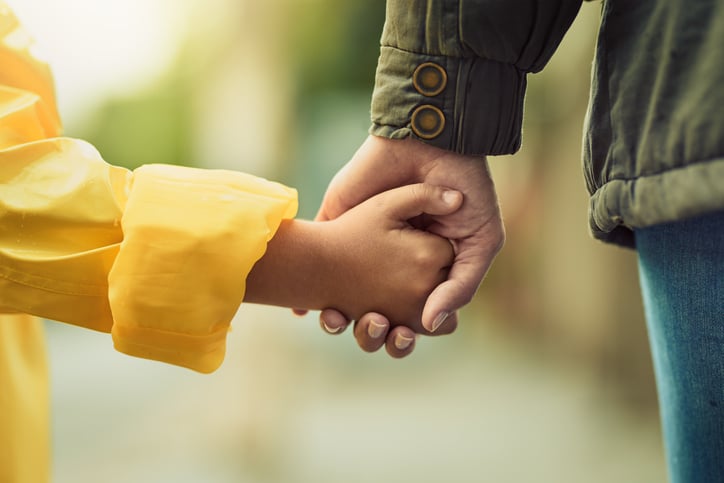 parent and child holding hands