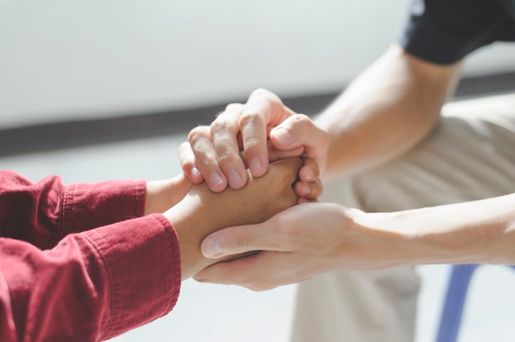 psychiatrist sitting and holding hands autism