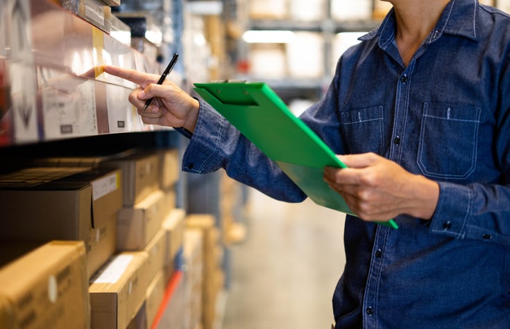 student with autism checking warehouse stock