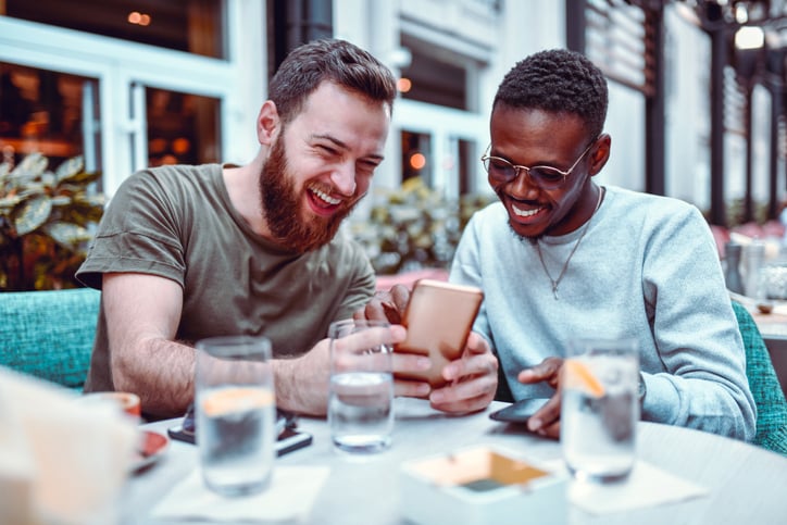 two friends discussing something on a phone