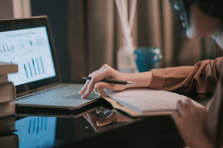 woman with autism studying notes online for college