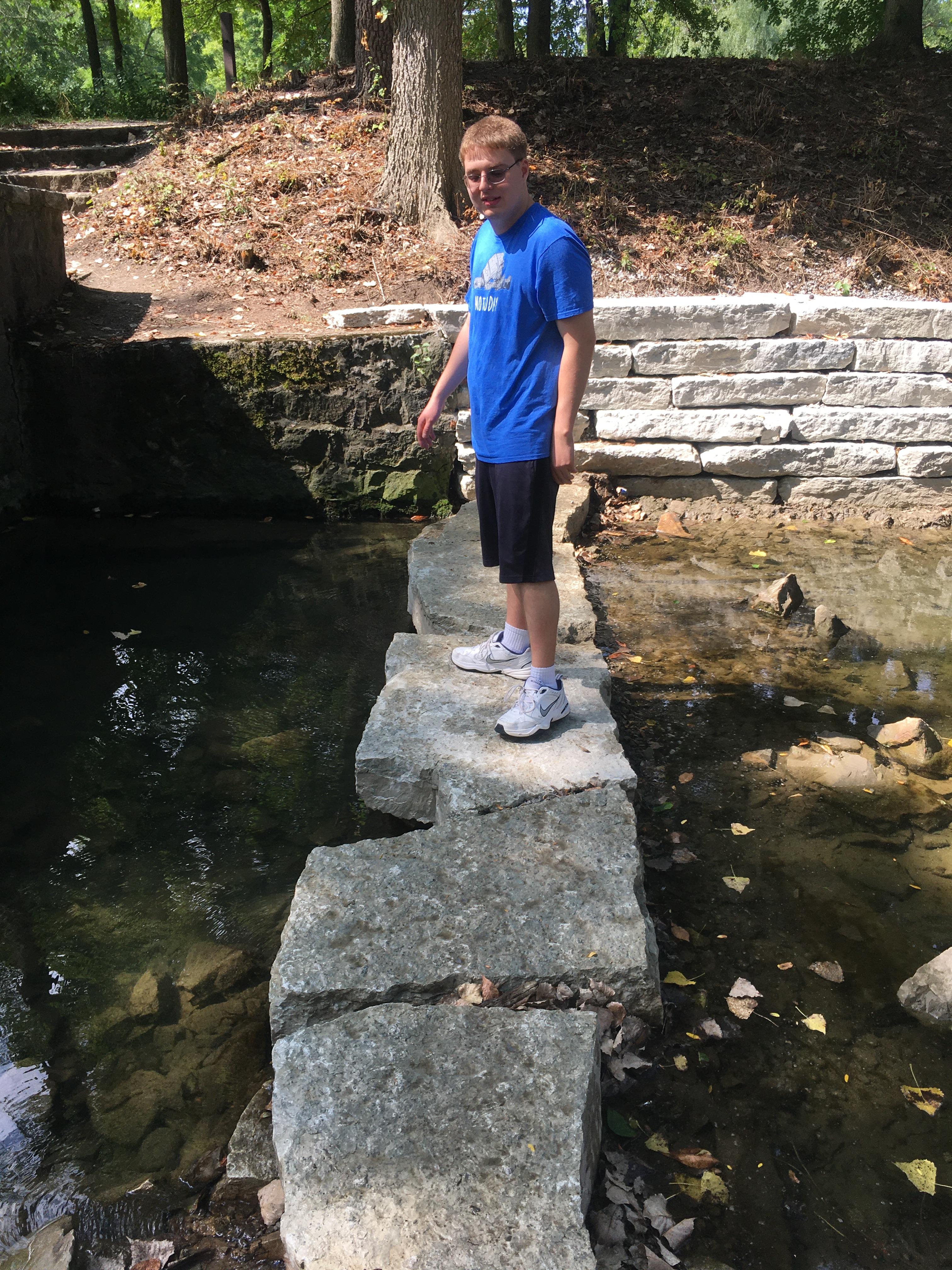 jim-at-creek-standing-on-rocks