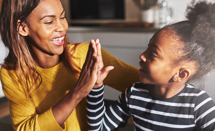 mother and daughter with autism high fiving