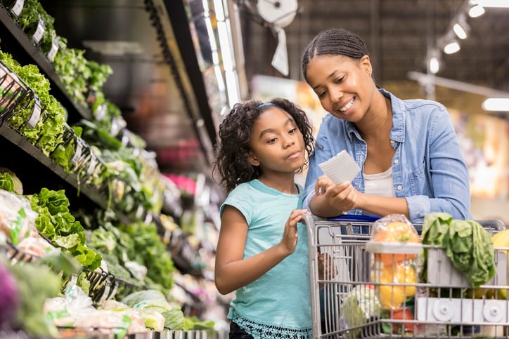 mother and daughter with autism looking at items on a paper shopping list