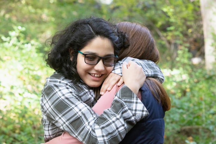 sisters with autism hugging