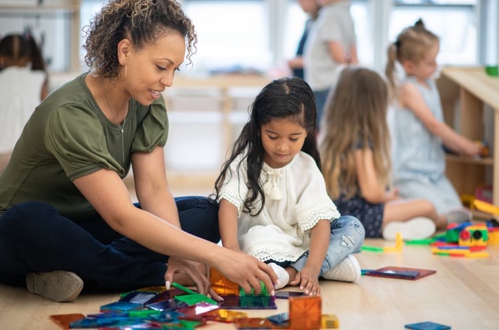 teacher and child with autism working together