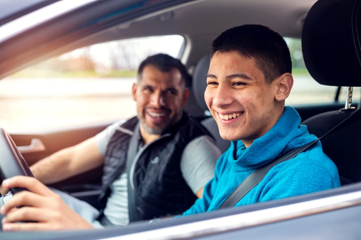 teenage boy with autism learning to drive with his dad