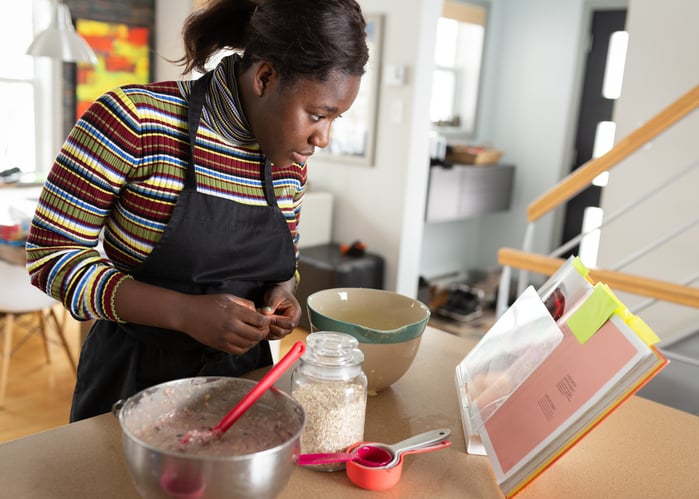 Teenager Girl with Autism Cooking Muffins for Breakfast