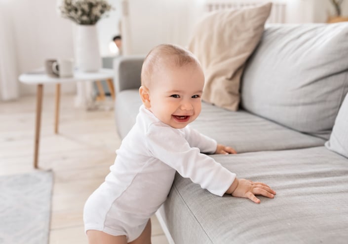 toddler pulling himself up to standing