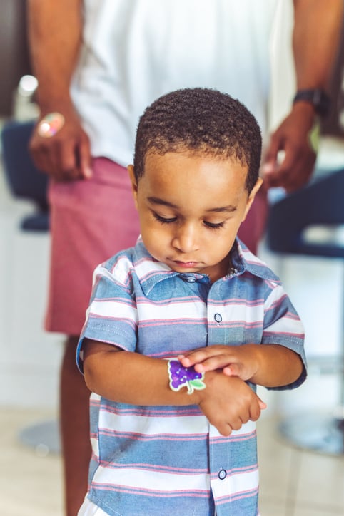 toddler with autism with a sticker
